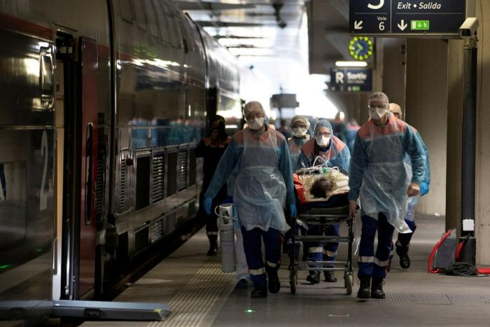 France’s medical officers stretcher a coronavirus patient from a fast train