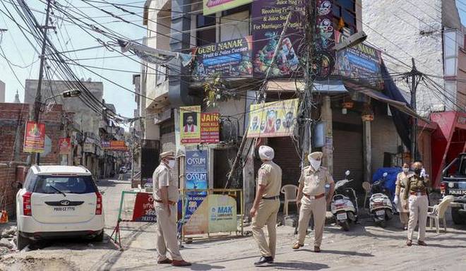 Policemen in Jalandhar, Punjab India guard a sealed house