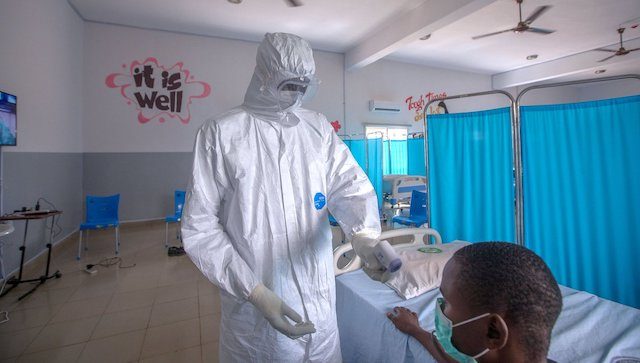 A medical officer and a COVID-19 patient in Nigeria