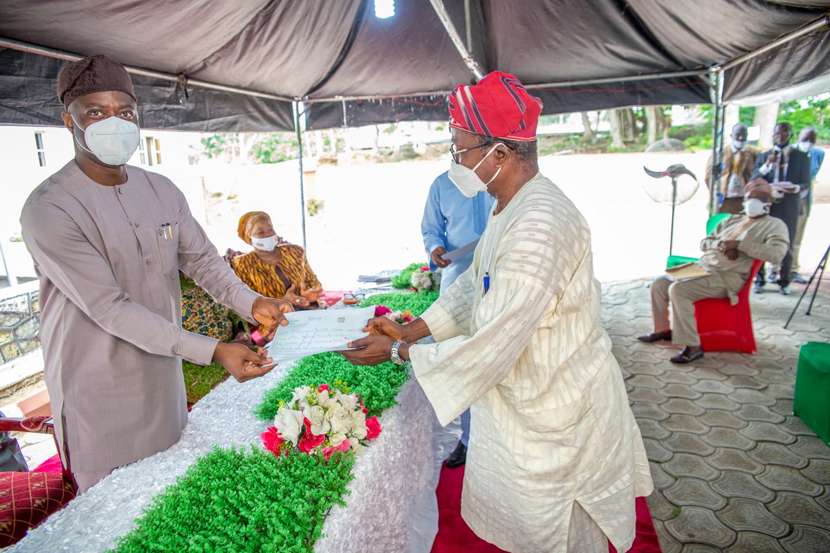 Governor Seyi Makinde, left presents payment vouchers to one of the pensioners