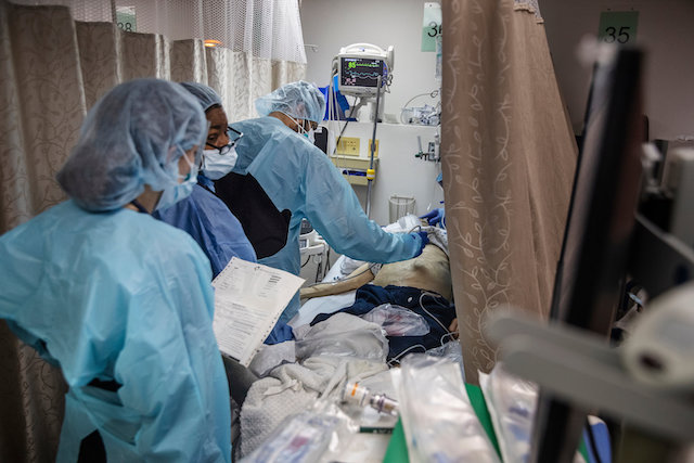 A doctor checks a coronavirus patient in a New York hospital