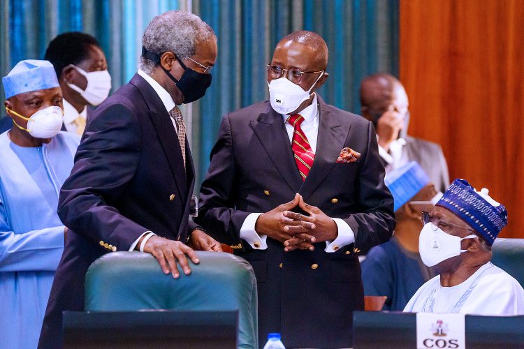 Minister of Work and Housing, Babatunde Fashola discussing with other exco members during the virtual FEC meeting president over by Buhari in Abuja