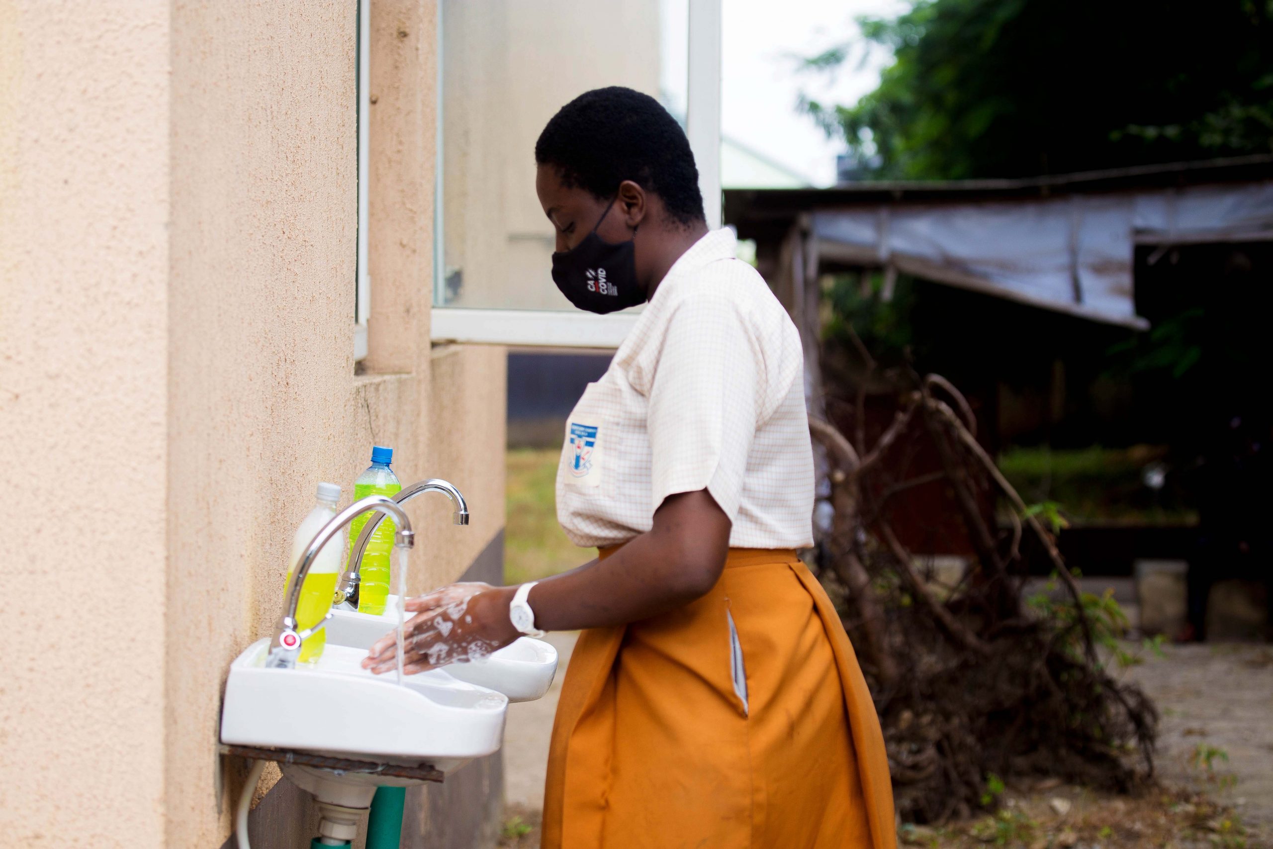 A student washing her hands at a school in Agindingbi area of Lagos State, Nigeria, today