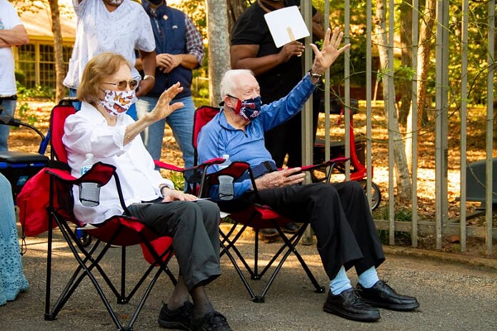 Jimmy Carter andd his wife Rosalyn wave to birthday wishers