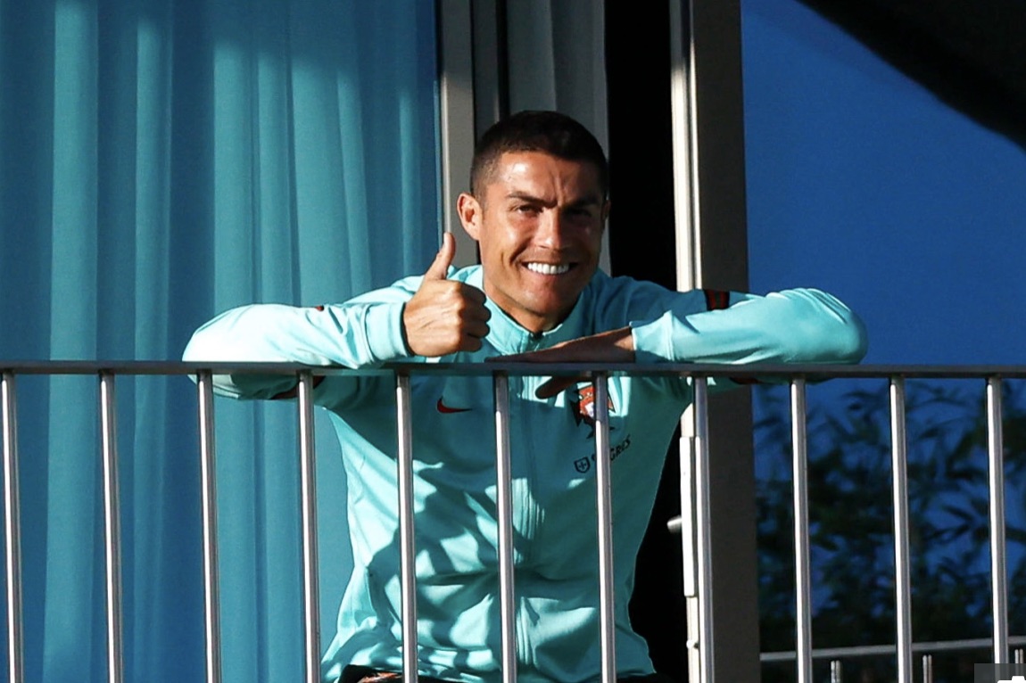 Ronaldo gestures to team mates on Tuesday after his diagnosis