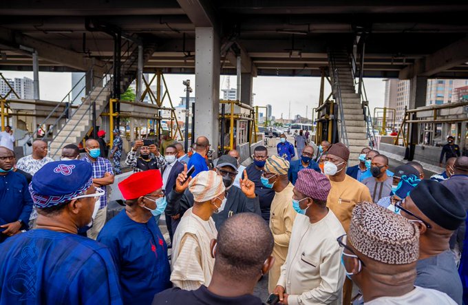 Sanwo-olu and his visitors at the toll gate in Lekki