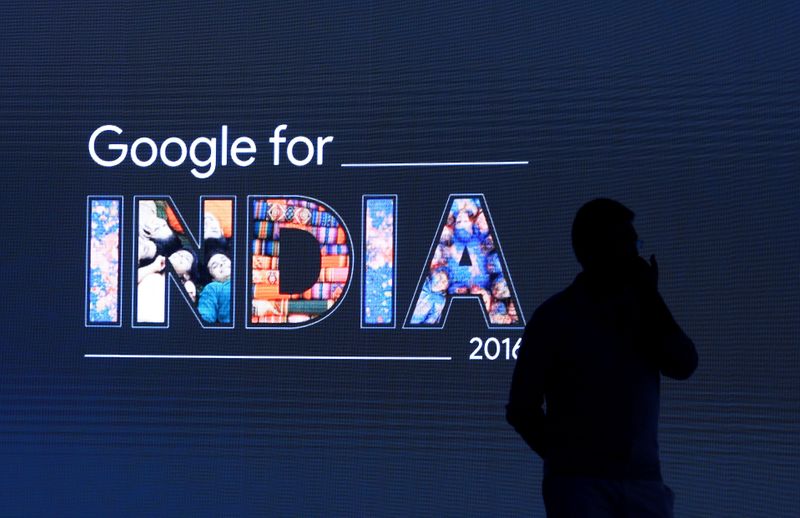 FILE PHOTO: Man stands in front of a screen during a Google event in New Delhi