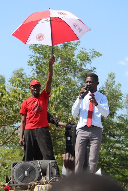 Bobi Wine, right campaigning before his arrest on Wednesday