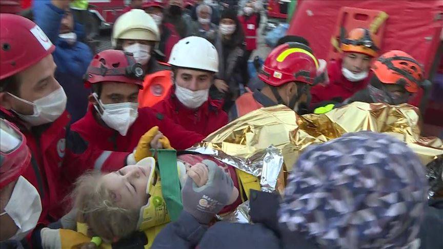 three year-old Elif being taken away by rescue agents on Monday
