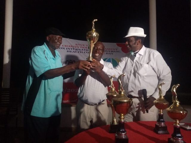 Ben Okoro, right receives Charity Golf Tournament trophy from IBM Haruna