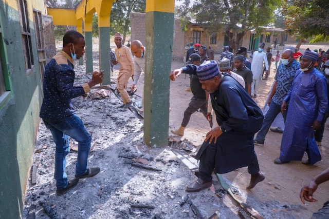 Zulum entering one of the buildings burnt by Boko Haram