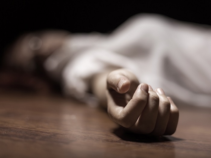 Dead woman’s body with focus on hand