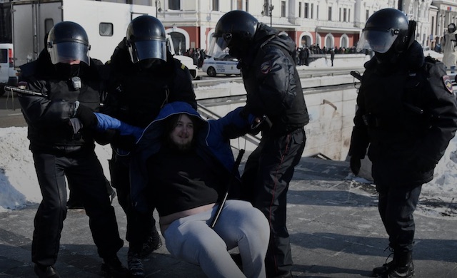 Police detain a pro-Alexei Navalny supporter in Moscow