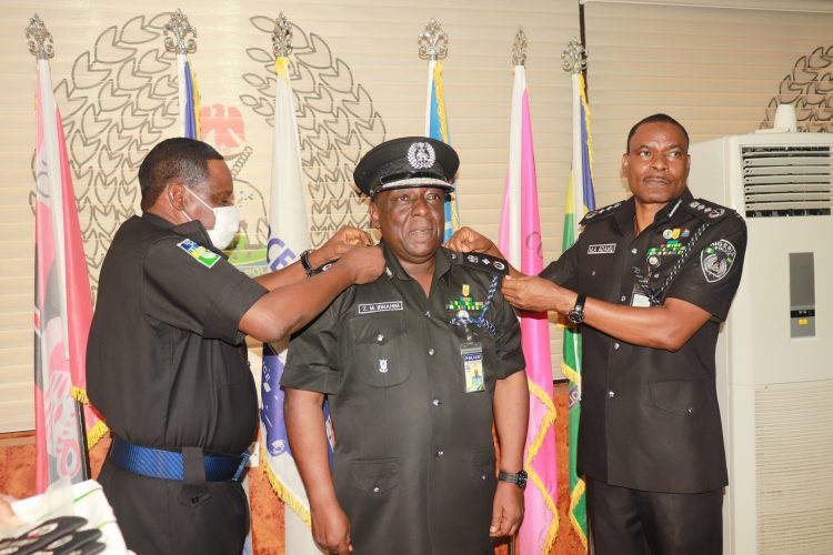 The IGP alongside DIG Training decorating DIG Zanna Ibrahim, mni with his new rank