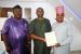 The Oyo NUJ Chairman, Com. Demola Babalola (right) receiving acceptance letter to be the union patron from Dr. Henry Akinduro (middle) Chairman, Total Grace Group at his Lagos office while Secretary of the Union, Com. Olusola Oladapo looks on.