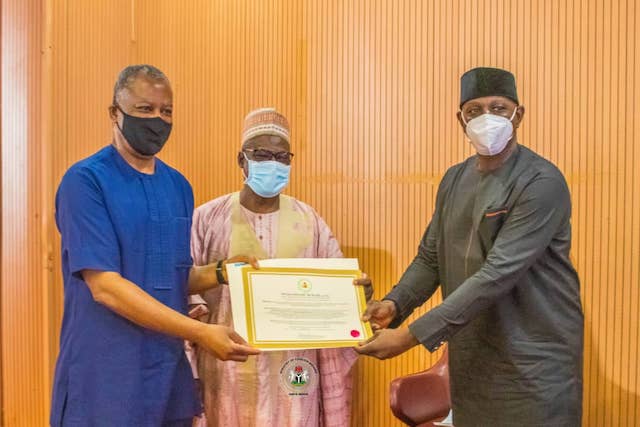 Onyeama, left gives the letter of credence to one of the new ambassadors