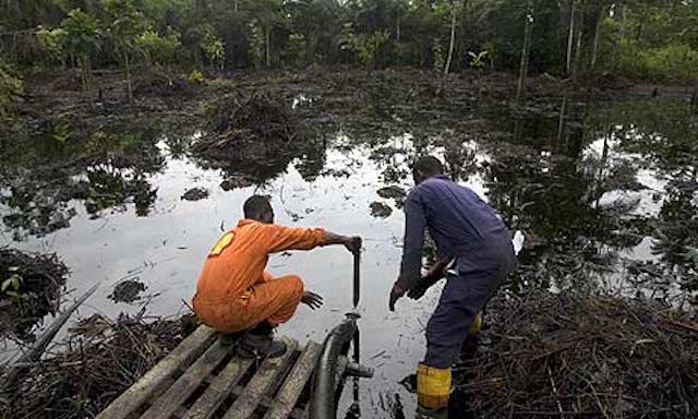 A Shell worker at an oil spill site