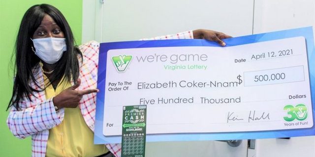 Elizabeth Tutu Coker-Nnam with her prize check.