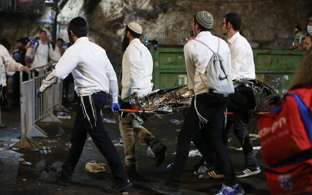 .the dead being carried away by medics at Mount Meron Israel on Friday