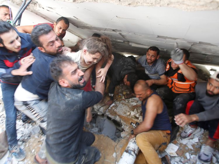rescuers pull a girl from the rubble after Israeli air strike in Gaza