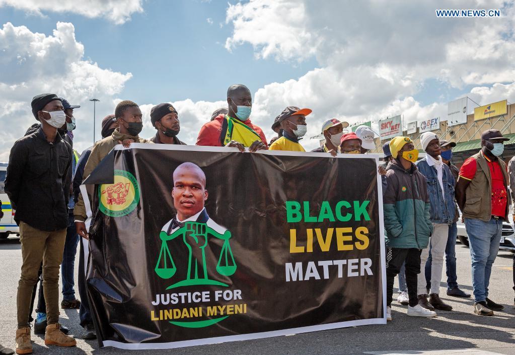 People protest as the remains of the late South African rugby player Lindani Myeni arrived at OR Tambo International Airport in Johannesburg, South Africa, May 1, 2021.