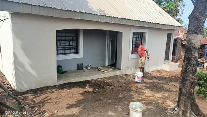 A painter puts gloss on the bungalow