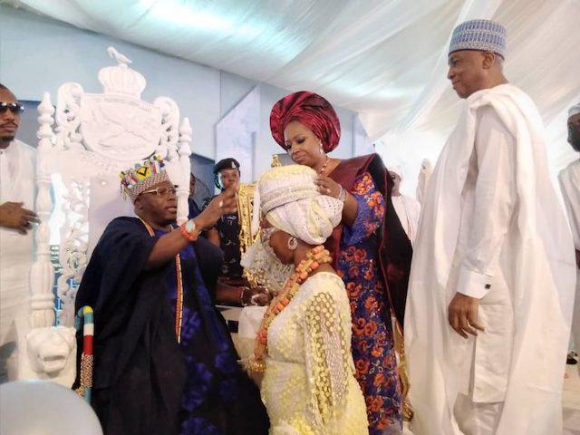 Oba Lawal decorates  Toyin Saraki, with Bukola Saraki with her title as Senator Saraki watches