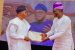 Gov. Oyetola presents a bond certificate to one of the Osun retirees