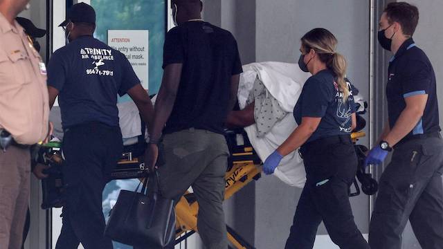 Martine Moise being stretchered into Miami hospital