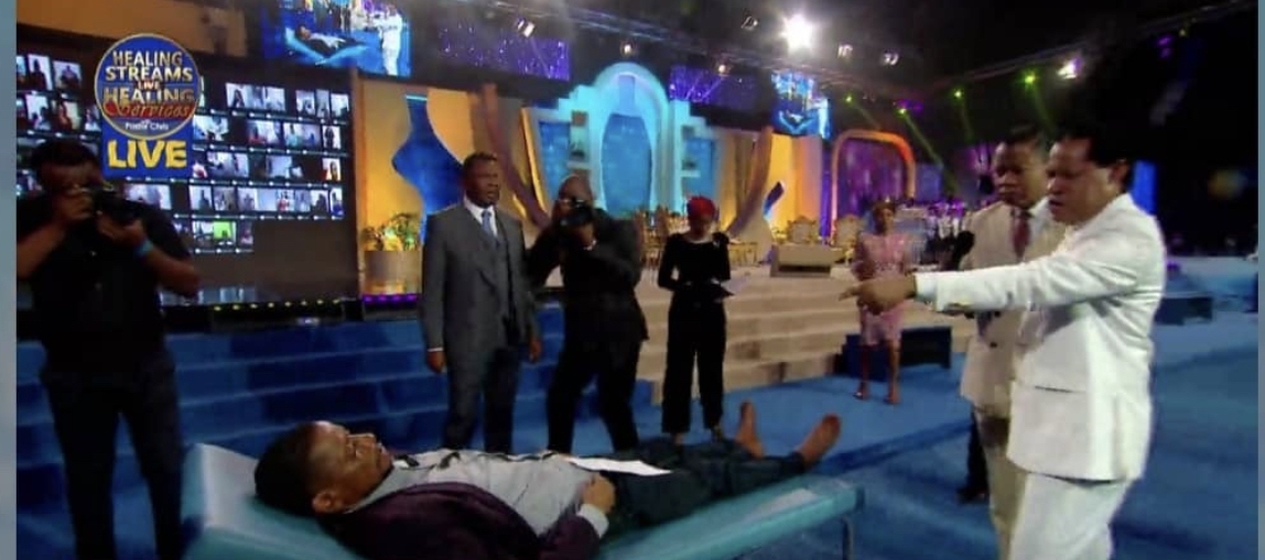 Pastor Chris ministering to a bedridden man who received healing afterwards