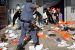 A policeman tries to control looting by Zuma rioters