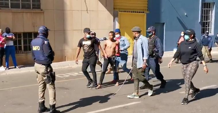 A rioter in South Africa being arrested by police in Johannesburg