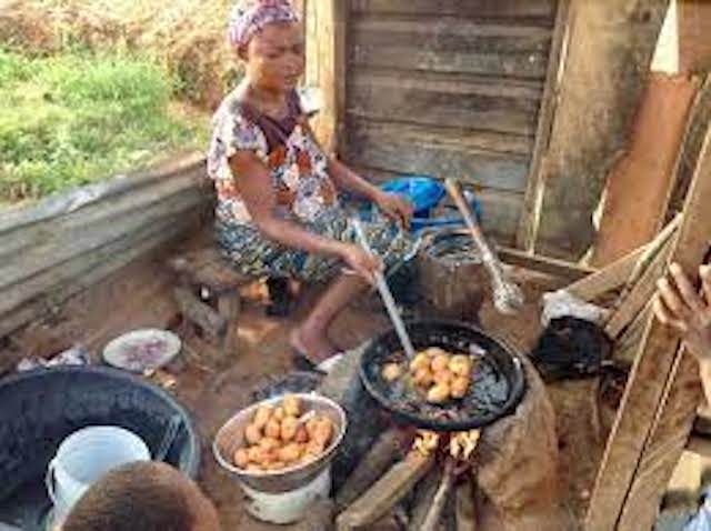 A woman fries Akara or bean cake outside Chukuku in Abuja