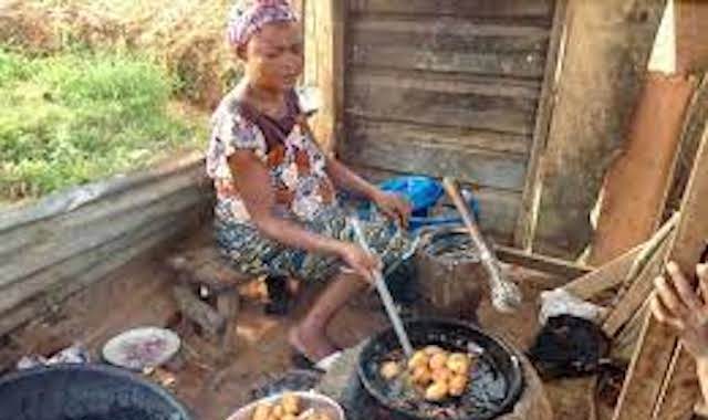 A woman fries Akara or bean cake outside Chukuku in Abuja