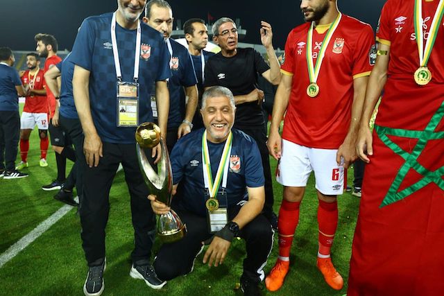 Al Ahly officials pose with the Total CAF Champions League trophy