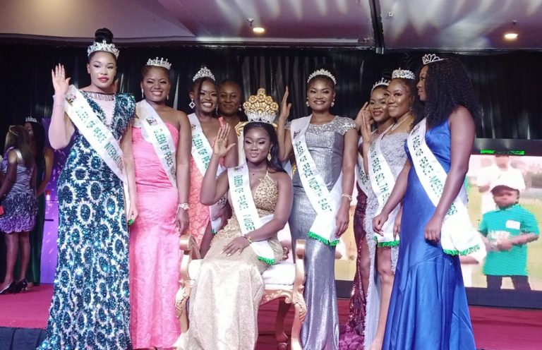 2021 Queen of Peace, Nigeria, Miss Ajuma Abah (fitted) surrounded by the other winners