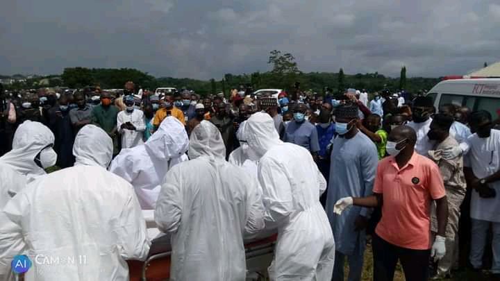 Men in PPE with Mantu's body