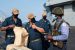 A Nigerian Navy sailor, far right, meets crewmembers of the USS Hershel Woody Williams prior to exercises in the Gulf of Guinea.