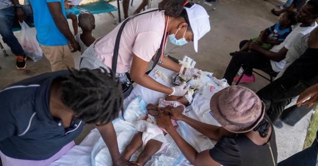 A baby victim of Haiti earthquake gets medical attention