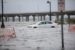 A car wades through flooded road in Louisiana amid Hurricane Ida