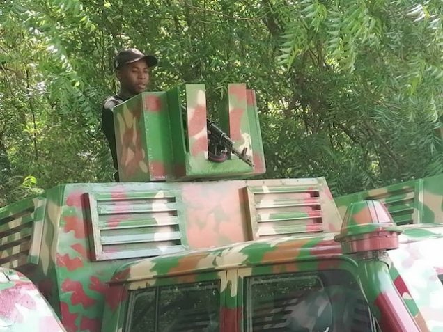 Combat ready: a soldier mounts the Toyota Landcruiser turrned armoured vehicle