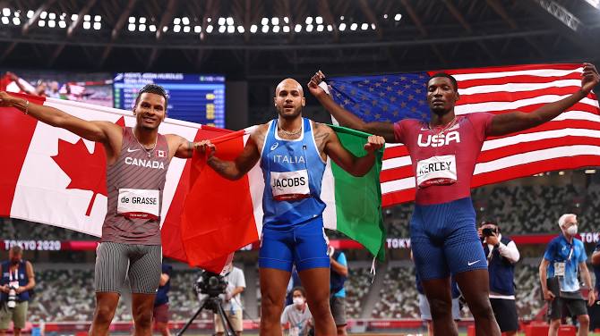 Jacobs of Italy, middle, win the Tokyo Olympics 100 metres gold