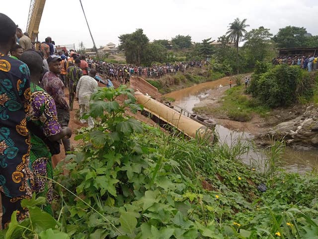 Passersby watch the ruins of the accident