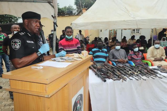 Police Commissioner Frank Mba with the 39 suspects paraded on Monday