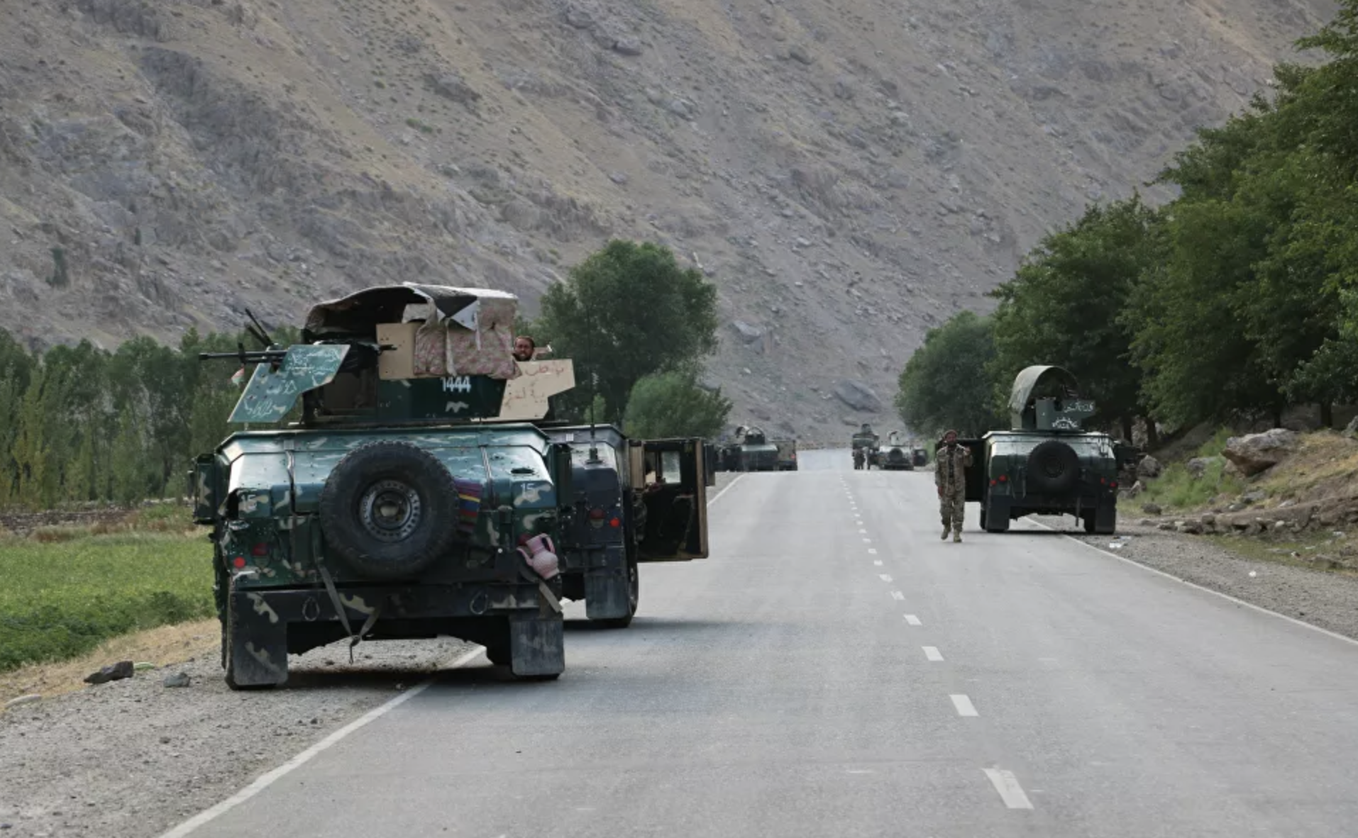 Afghan soldiers fighting Taliban pause near the city of Badakhshan before it was overrun
