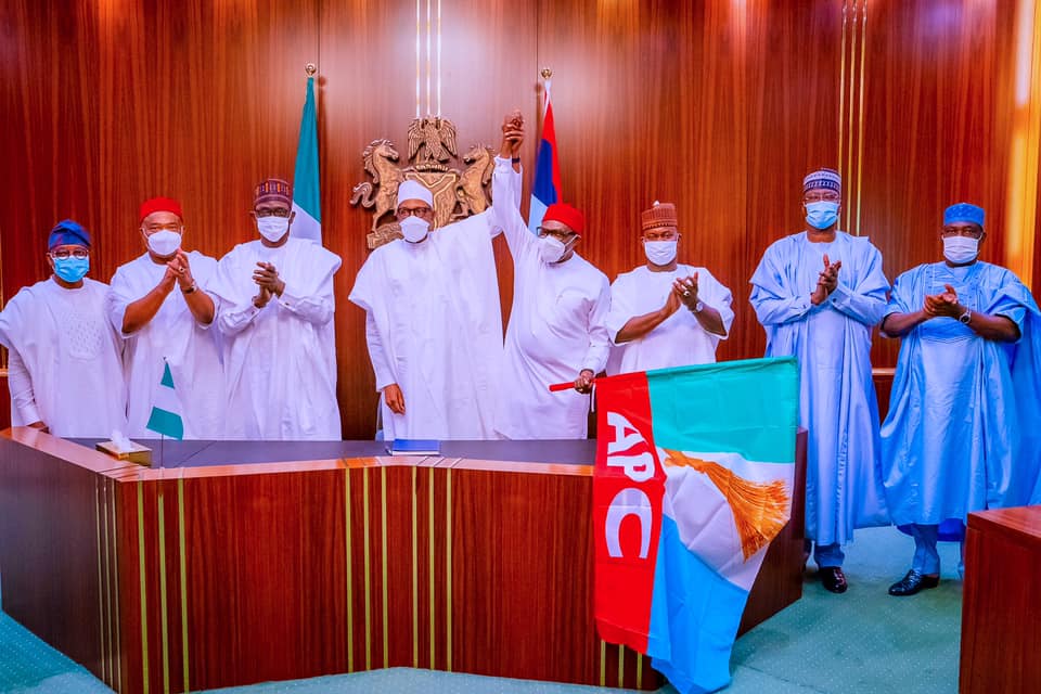 Buhari presents APC flag to Andy Uba, with governors, others present