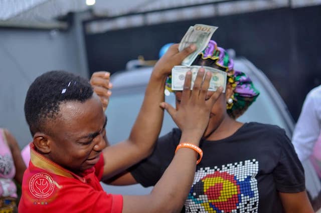 Agochukwu sprays his wife $100 notes as well