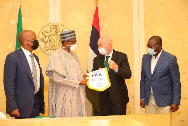 Buhari gets the FIFA flag from Infantino