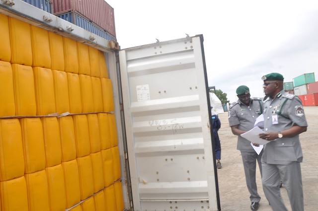 File: Customs officials examine a container at Tin Can Island port