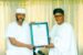 Dr Tom Ohikere, the Publisher APC Online News, presenting a Letter of Credence to Kogi Deputy Governor, Edward Onoja